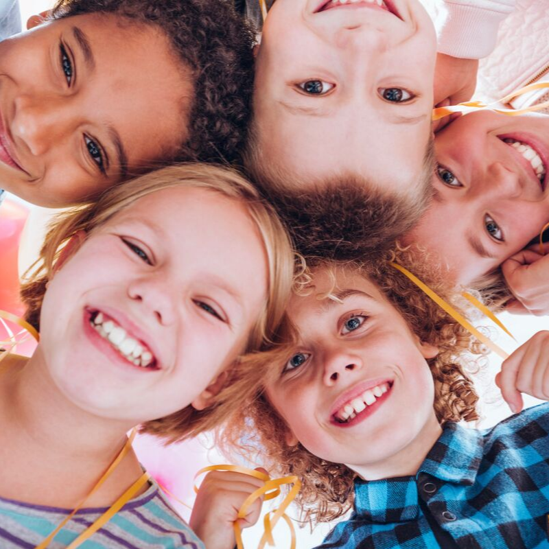 Photo of children looking into camera