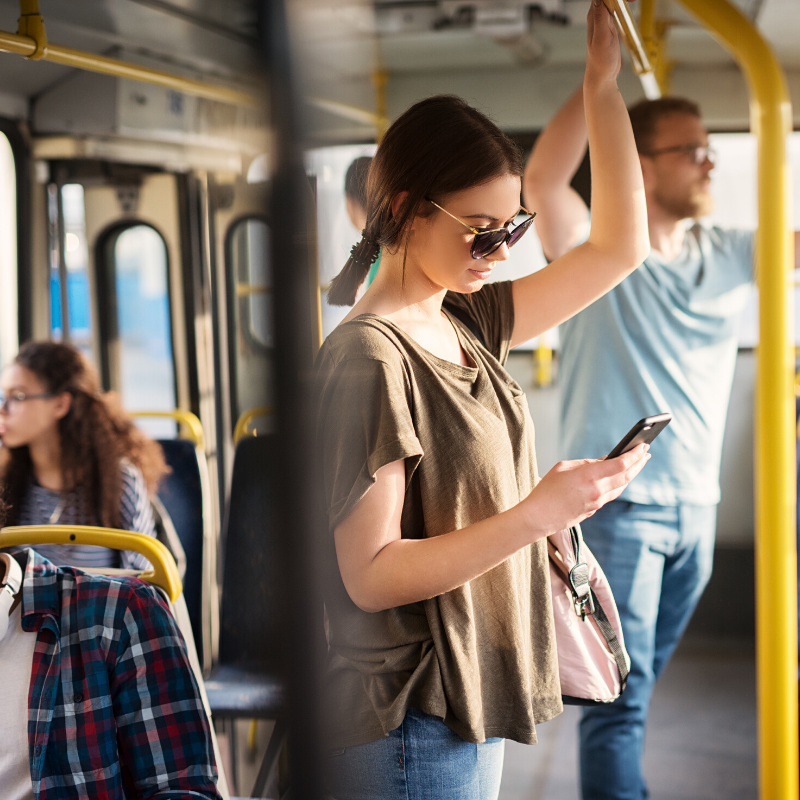 Photo of girl looking at cell phone on a bus